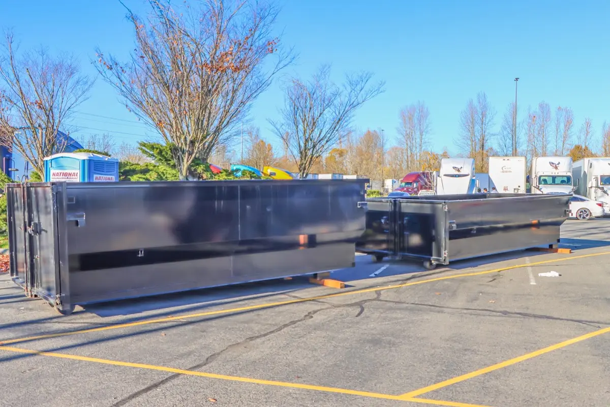 Professional dumpster rental service with roll-off container on residential driveway in El Cajon